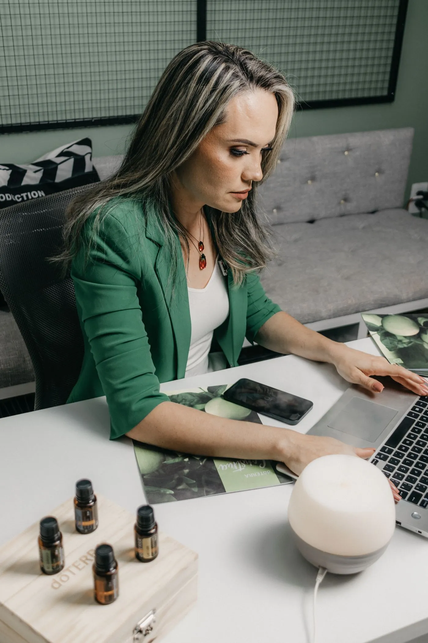 A business owner working on a laptop at her desk